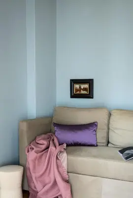 a couch with a blanket on it in a living room at Bonjour Athens in Athens