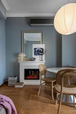 a living room with a table and a fireplace at Bonjour Athens in Athens