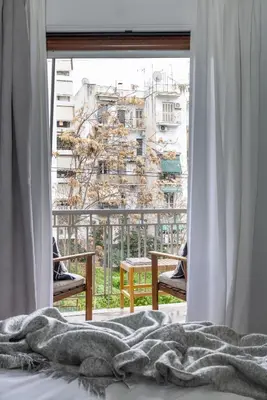 a bedroom with a window with a view of a building at Bonjour Athens in Athens