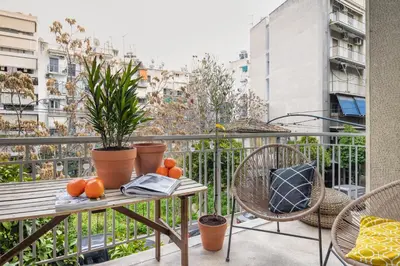 a balcony with a table with oranges on it at Bonjour Athens in Athens