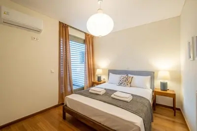 a bedroom with a bed with two towels on it at Award-winning apartments in Athens