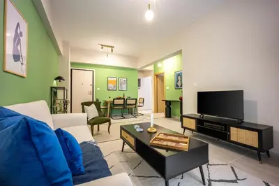 a living room with a couch and a tv at Modern Central Apartment with Balcony - Near Metro in Athens