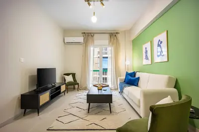 a living room with a couch and a tv at Modern Central Apartment with Balcony - Near Metro in Athens