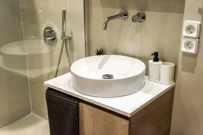 a bathroom with a white sink and a shower at Modern Central Apartment with Balcony - Near Metro in Athens