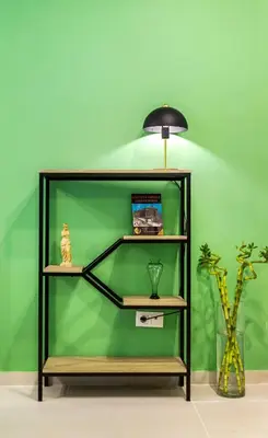 a shelf with a lamp and a green wall at Modern Central Apartment with Balcony - Near Metro in Athens