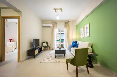 a living room with a couch and a tv at Modern Central Apartment with Balcony - Near Metro in Athens