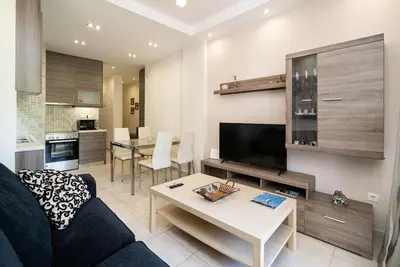 a living room with a couch and a table at Acropolis Nest in Athens