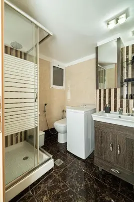 a bathroom with a shower and a toilet and a sink at Acropolis Nest in Athens