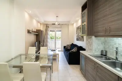 a kitchen and living room with a glass table at Acropolis Nest in Athens