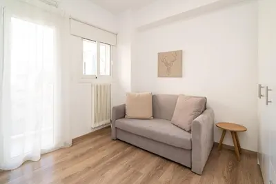 a living room with a couch and a window at Athens Casa Dell 'Imperatore in Athens