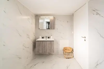 a white bathroom with a sink and a mirror at Athens Casa Dell 'Imperatore in Athens