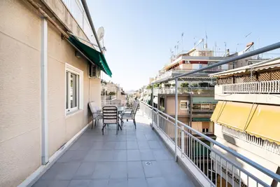 a balcony with chairs and a table on a building at Athens Casa Dell 'Imperatore in Athens