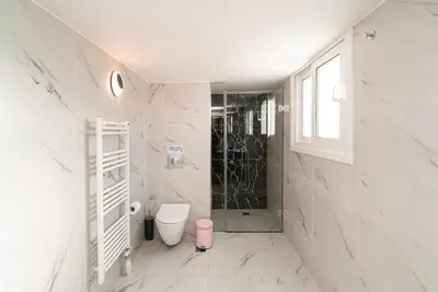 a white bathroom with a shower and a toilet at Athens Casa Dell 'Imperatore in Athens