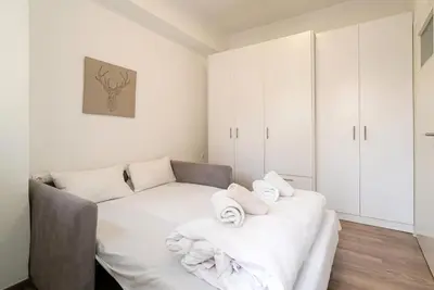 a white room with a couch and towels at Athens Casa Dell 'Imperatore in Athens