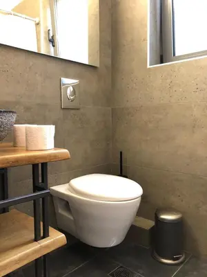 a bathroom with a white toilet and a mirror at Luxurious apartment with big balconyBEST location in Athens