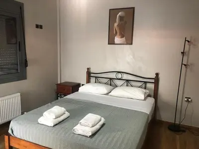 a bedroom with a bed with two towels on it at Luxurious apartment with big balconyBEST location in Athens