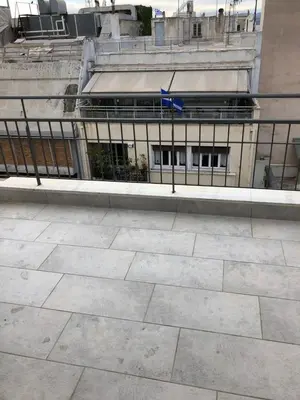 a building with a fence in front of it at Luxurious apartment with big balconyBEST location in Athens