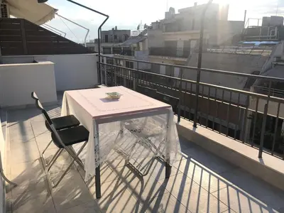 a table and a chair on a balcony at Luxurious apartment with big balconyBEST location in Athens