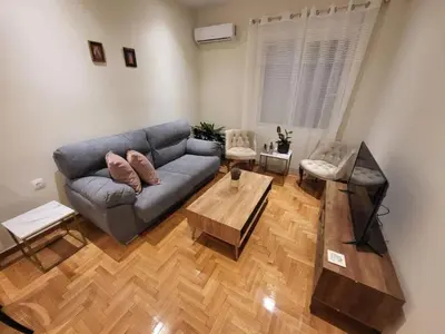 a living room with a couch and a table at 2 bd renovated flat at acropolis in Athens