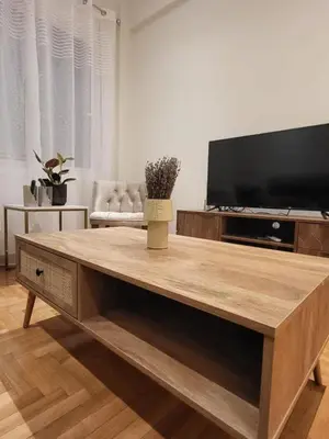 a living room with a large wooden coffee table at 2 bd renovated flat at acropolis in Athens