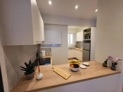 a kitchen with a counter with a bowl of fruit on it at 2 bd renovated flat at acropolis in Athens