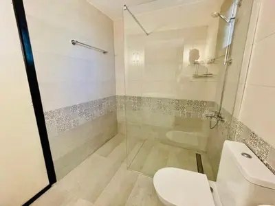 a bathroom with a glass shower and a toilet at Villa Pharaoh Private Pool Near the Beach in Porto Rafti