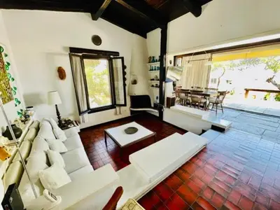 a living room with a white couch and a table at Villa Pharaoh Private Pool Near the Beach in Porto Rafti