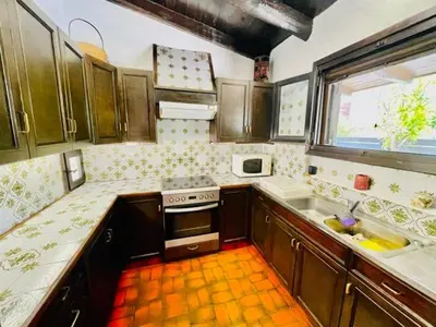 a kitchen with a stove and a sink and a window at Villa Pharaoh Private Pool Near the Beach in Porto Rafti