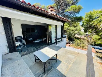 a bench sitting on a patio of a house at Villa Pharaoh Private Pool Near the Beach in Porto Rafti