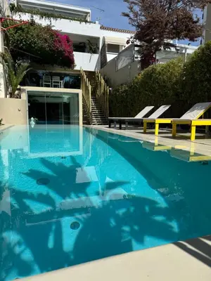 a swimming pool with fish in the water at VILLA LAGUNA BLUE - Kavouri Vouliagmeni BEACH FRONT in Athens
