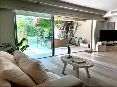 a living room with a couch and a table at VILLA LAGUNA BLUE - Kavouri Vouliagmeni BEACH FRONT in Athens