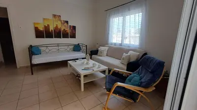 a living room with a couch and a table at Armonia's Apartment in Piraeus