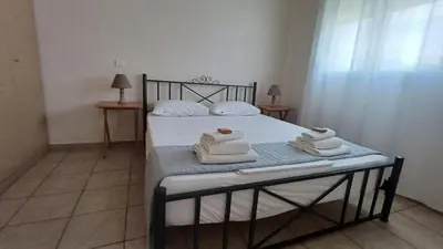 a bedroom with a bed with towels on it at Armonia's Apartment in Piraeus