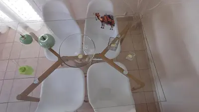 a bathroom with a toilet with a glass shelf above it at Armonia's Apartment in Piraeus