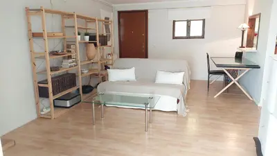 a living room with a couch and a glass table at COZY Apt BY THE SEA AT VOULIAGMENI in Athens