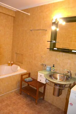 a bathroom with a sink and a bath tub at COZY Apt BY THE SEA AT VOULIAGMENI in Athens