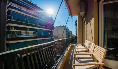 a row of benches sitting on a balcony at Acropolis Sunny Flat in Athens