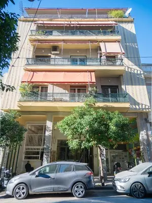 two cars parked in front of a building at Acropolis Sunny Flat in Athens