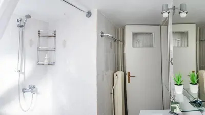 a bathroom with a shower with a glass door at Acropolis Sunny Flat in Athens