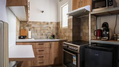 a small kitchen with a stove and a sink at Acropolis Sunny Flat in Athens