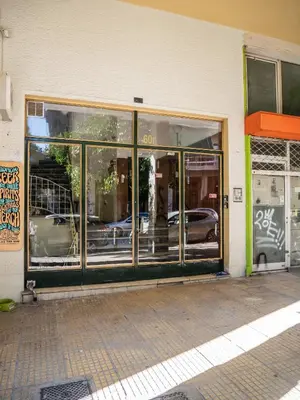 a store front with glass doors with cars in it at Acropolis Sunny Flat in Athens