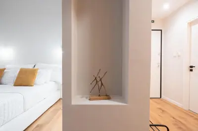a living room with a white couch and a window at 