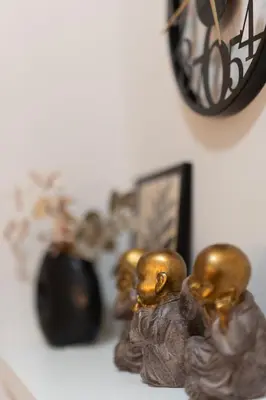 a group of gold figurines sitting next to a clock at 