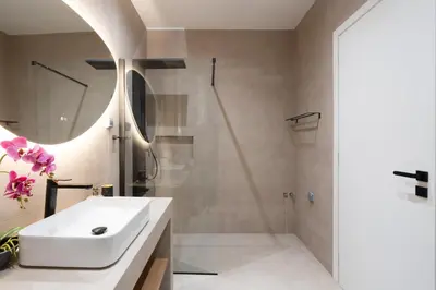 a bathroom with a white sink and a shower at 