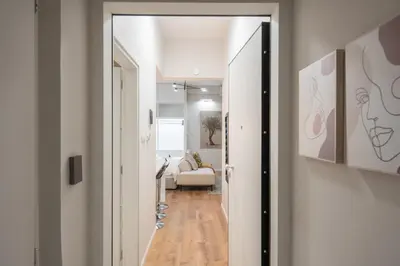 a hallway leading to a living room with a couch at 