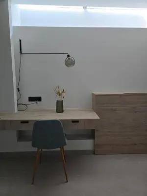 a desk with a chair and a lamp on it at Spacious Minimalistic Loft ,5 minutes walk to Metro in Athens