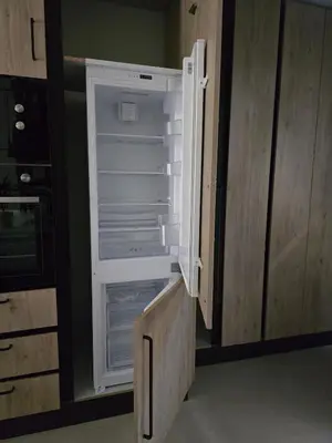 an empty refrigerator with its door open in a kitchen at Spacious Minimalistic Loft ,5 minutes walk to Metro in Athens
