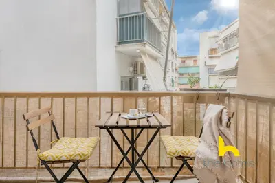 a table and two chairs on a balcony at Kaimaki in Athens