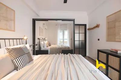 a bedroom with a bed and a large mirror at Kaimaki in Athens