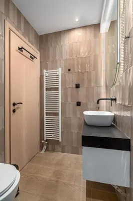 a bathroom with a sink and a toilet at Rizes Suites Metro Dafni in Athens